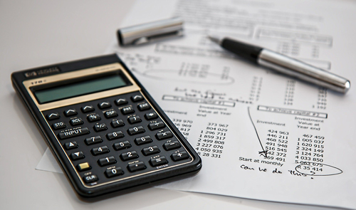 calculadora con papeles en mesa